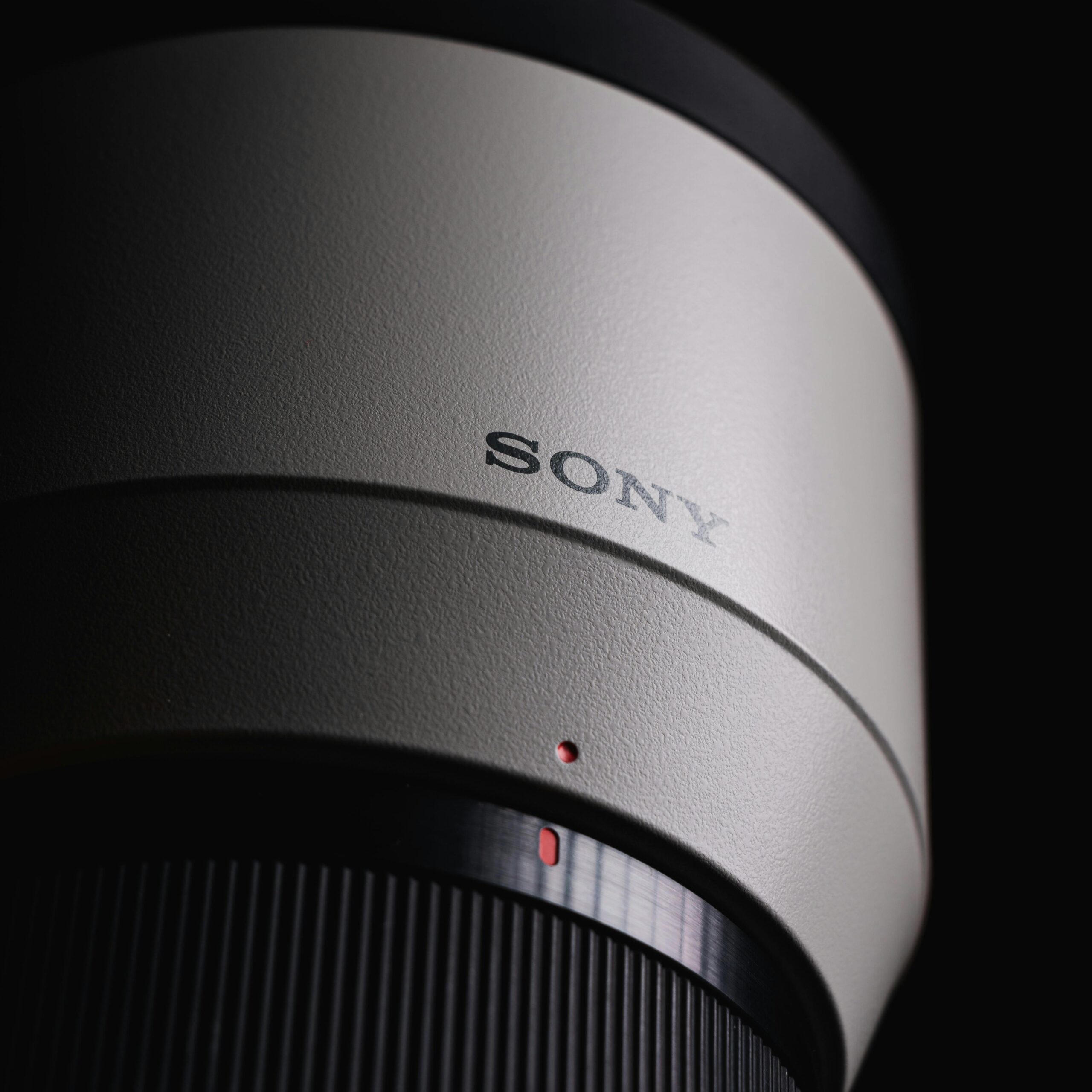 Detailed close-up of a modern camera lens showing texture and design, ideal for creative projects.